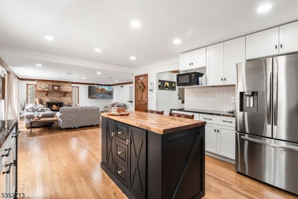 Fireplace, Interior, Kitchen, Living room, Recessed Lighting, Stainless Steel Appliances, Stone Walls, Wood Texture Flooring