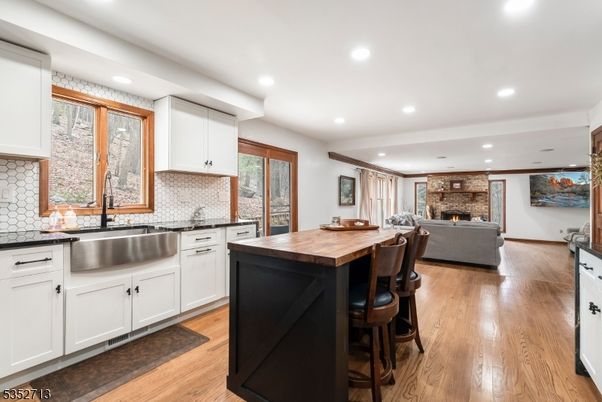 Fireplace, Interior, Kitchen, Living room, Recessed Lighting, Stone Walls, Wood Texture Flooring