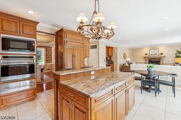 Chandelier, Dining room, Fireplace, Interior, Kitchen, Living room, Recessed Lighting, Stainless Steel Appliances