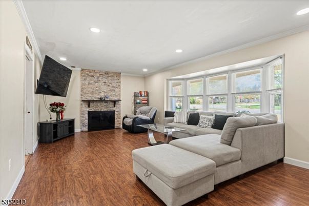 Fireplace, Interior, Living room, Recessed Lighting, Stone Walls, Wood Texture Flooring