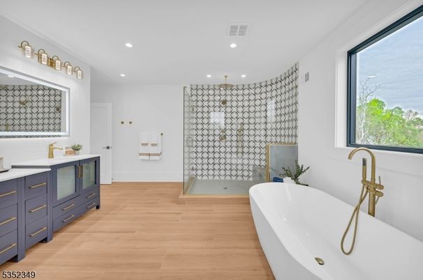 Bathroom, Dual Sink Vanities, Free Standing Baths, Interior, Pendant Lights, Recessed Lighting, Wood Texture Flooring