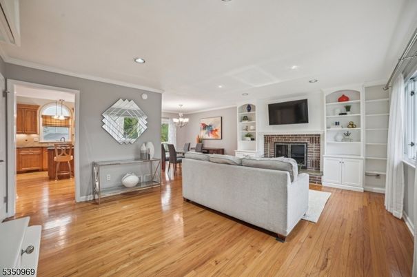 Chandelier, Dining room, Fireplace, Interior, Living room, Pendant Lights, Recessed Lighting, Wood Texture Flooring