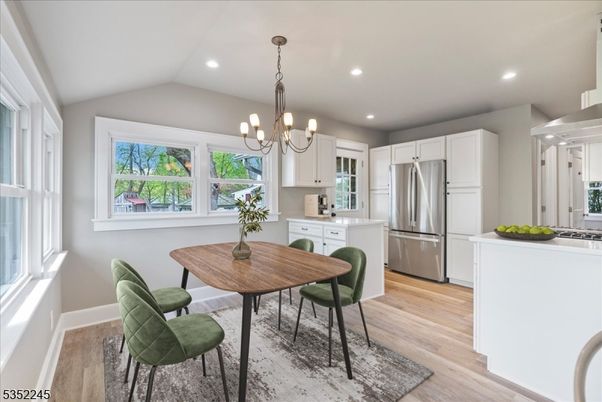 Chandelier, Dining room, Interior, Kitchen, Pendant Lights, Recessed Lighting, Stainless Steel Appliances, Wood Texture Flooring