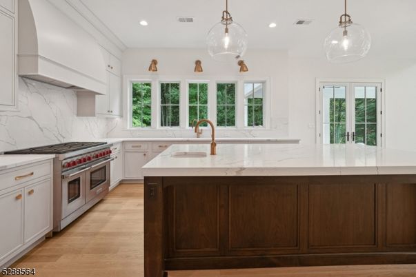 Interior, Kitchen, Marble Walls, Pendant Lights, Recessed Lighting, Stainless Steel Appliances, Wood Texture Flooring