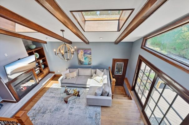 Chandelier, Fireplace, Interior, Living room, Piano, Wooden Beams, Wood Texture Flooring