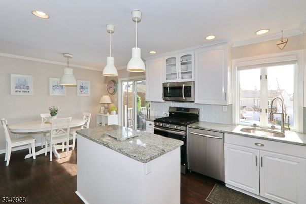 Dining room, Interior, Kitchen, Pendant Lights, Recessed Lighting, Stainless Steel Appliances, Wood Texture Flooring
