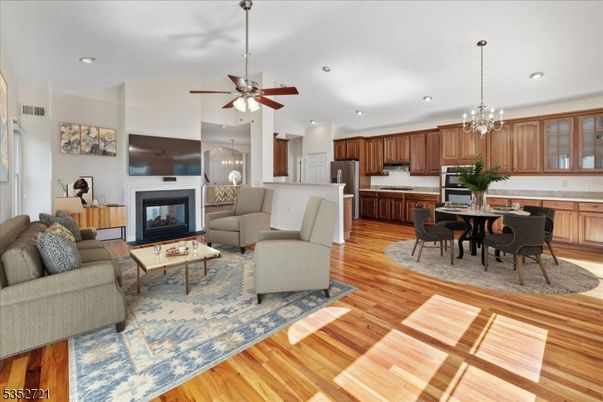 Chandelier, Dining room, Fireplace, Interior, Kitchen, Living room, Pendant Lights, Recessed Lighting, Stainless Steel Appliances, Wood Texture Flooring