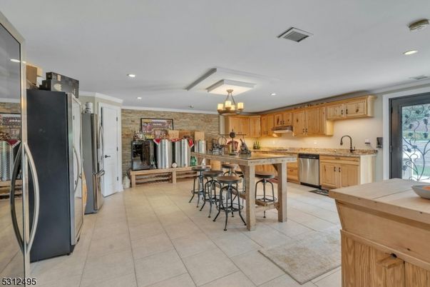 Chandelier, Fireplace, Interior, Kitchen, Recessed Lighting, Stainless Steel Appliances, Stone Walls