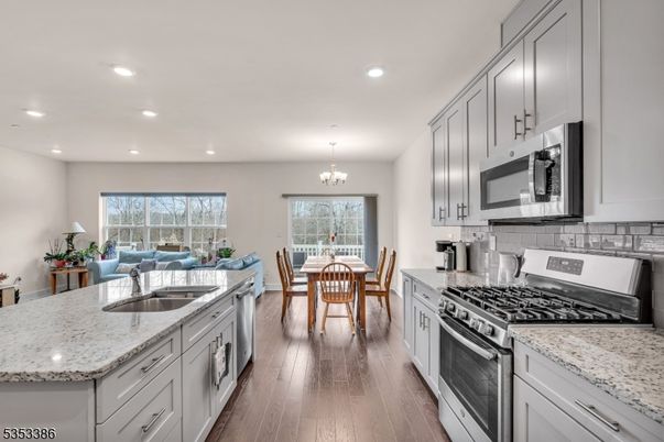 Chandelier, Dining room, Interior, Kitchen, Recessed Lighting, Stainless Steel Appliances, Wood Texture Flooring