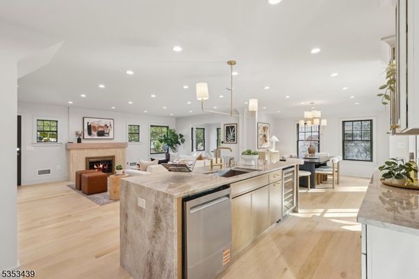 Chandelier, Dining room, Fireplace, Interior, Kitchen, Living room, Pendant Lights, Recessed Lighting, Stainless Steel Appliances, Wood Texture Flooring