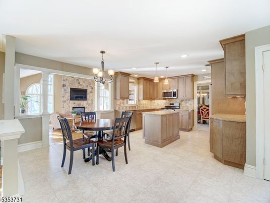 Chandelier, Dining room, Fireplace, Interior, Kitchen, Pendant Lights, Recessed Lighting, Stainless Steel Appliances, Stone Walls