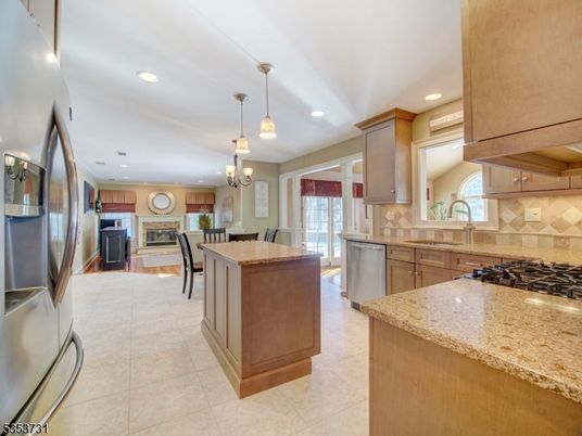 Chandelier, Dining room, Fireplace, Interior, Kitchen, Living room, Pendant Lights, Recessed Lighting, Stainless Steel Appliances