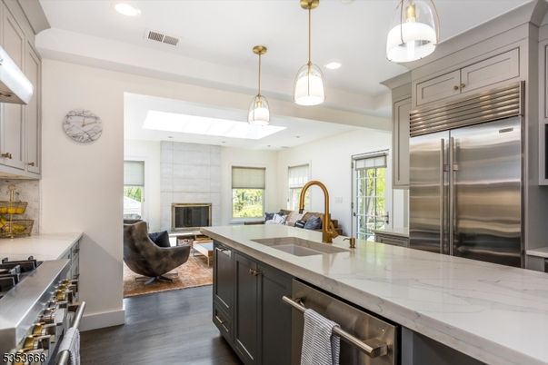 Fireplace, Interior, Kitchen, Living room, Pendant Lights, Recessed Lighting, Stainless Steel Appliances, Wood Texture Flooring
