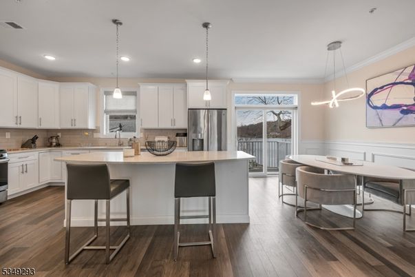 Dining room, Interior, Kitchen, Pendant Lights, Recessed Lighting, Stainless Steel Appliances, Wood Texture Flooring