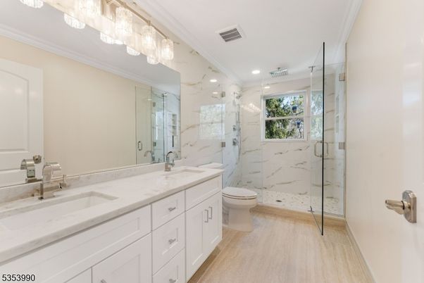 Bathroom, Dual Sink Vanities, Glass Shower, Interior, Marble Walls, Recessed Lighting, Wood Texture Flooring
