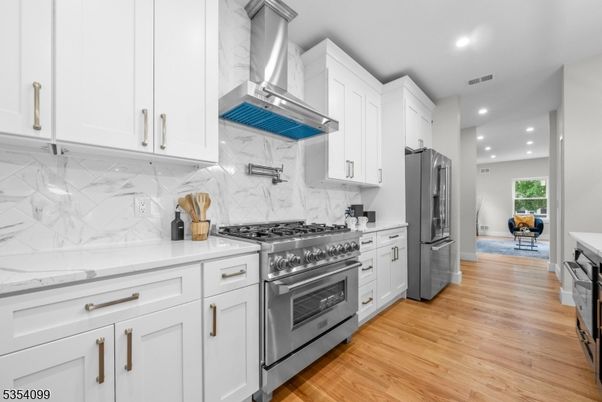 Interior, Kitchen, Marble Walls, Recessed Lighting, Stainless Steel Appliances, Wood Texture Flooring