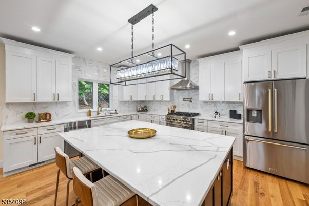 Interior, Kitchen, Marble Walls, Pendant Lights, Recessed Lighting, Stainless Steel Appliances, Wood Texture Flooring