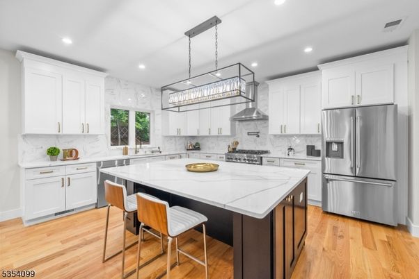 Interior, Kitchen, Marble Walls, Pendant Lights, Recessed Lighting, Stainless Steel Appliances, Wood Texture Flooring