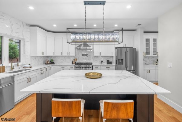 Interior, Kitchen, Marble Walls, Pendant Lights, Recessed Lighting, Stainless Steel Appliances, Wood Texture Flooring