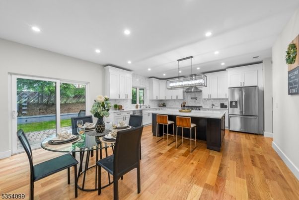 Dining room, Interior, Kitchen, Pendant Lights, Recessed Lighting, Stainless Steel Appliances, Wood Texture Flooring