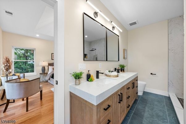 Bathroom, Dual Sink Vanities, Interior, Marble Walls, Recessed Lighting, Wood Texture Flooring