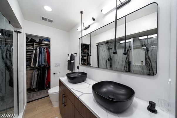 Bathroom, Dual Sink Vanities, Interior, Recessed Lighting, Walk-in Closets, Wood Texture Flooring