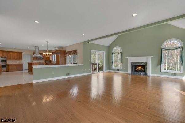 Chandelier, Empty room, Fireplace, Interior, Kitchen, Pendant Lights, Recessed Lighting, Wood Texture Flooring