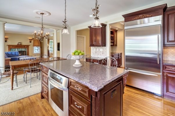 Chandelier, Dining room, Interior, Kitchen, Living room, Pendant Lights, Recessed Lighting, Stainless Steel Appliances, Wood Texture Flooring