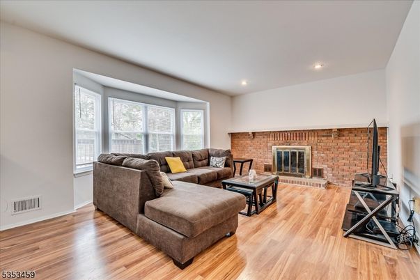 Fireplace, Interior, Living room, Recessed Lighting, Stone Walls, Wood Texture Flooring