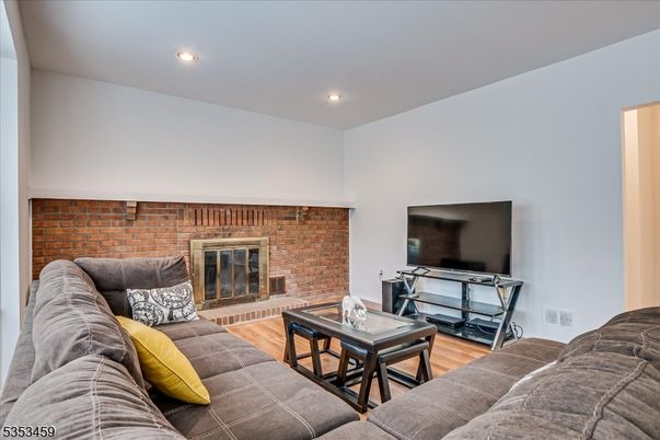 Fireplace, Interior, Living room, Recessed Lighting, Stone Walls, Wood Texture Flooring