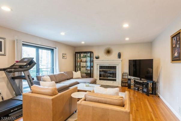 Fireplace, Fitness Equipment, Interior, Living room, Recessed Lighting, Wood Texture Flooring