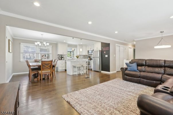 Chandelier, Dining room, Interior, Kitchen, Living room, Pendant Lights, Recessed Lighting, Stainless Steel Appliances, Wood Texture Flooring