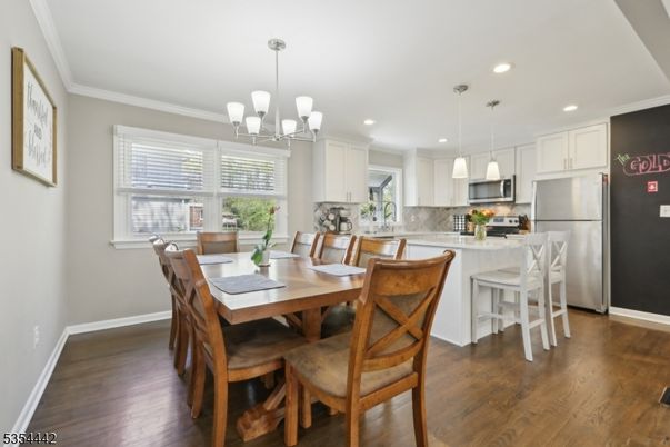 Chandelier, Dining room, Interior, Kitchen, Pendant Lights, Recessed Lighting, Stainless Steel Appliances, Wood Texture Flooring