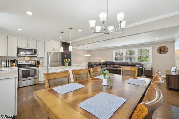 Chandelier, Dining room, Interior, Kitchen, Living room, Pendant Lights, Recessed Lighting, Stainless Steel Appliances, Wood Texture Flooring
