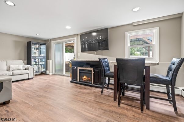 Dining room, Fireplace, Interior, Living room, Recessed Lighting, Wood Texture Flooring