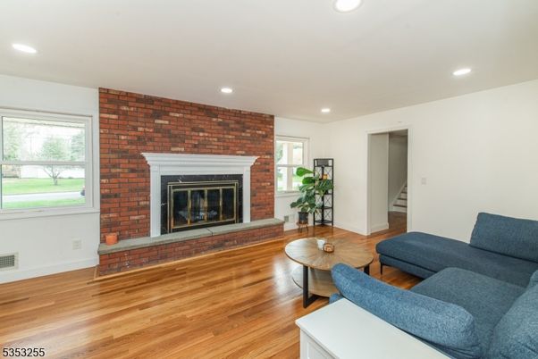 Fireplace, Interior, Living room, Recessed Lighting, Stone Walls, Wood Texture Flooring