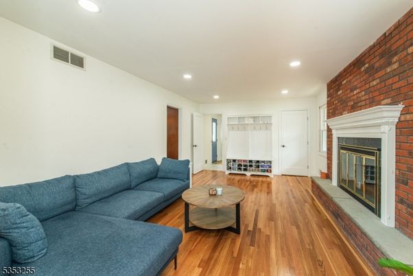 Fireplace, Interior, Living room, Recessed Lighting, Stone Walls, Wood Texture Flooring
