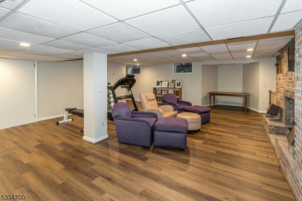 Fireplace, Fitness Equipment, Interior, Living room, Recessed Lighting, Stone Walls, Wood Texture Flooring