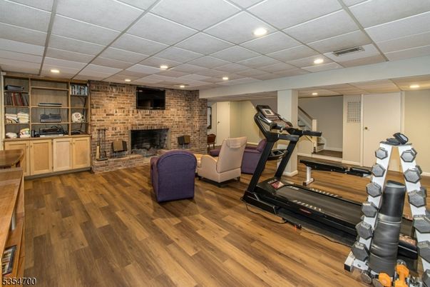 Fireplace, Fitness Equipment, Interior, Recessed Lighting, Stone Walls, Wood Texture Flooring
