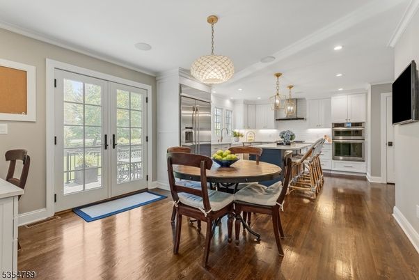 Chandelier, Dining room, Interior, Kitchen, Pendant Lights, Recessed Lighting, Stainless Steel Appliances, Wood Texture Flooring