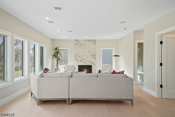 Fireplace, Interior, Living room, Marble Walls, Recessed Lighting, Wood Texture Flooring