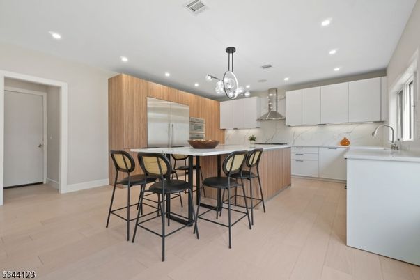 Interior, Kitchen, Marble Walls, Pendant Lights, Recessed Lighting, Stainless Steel Appliances, Wood Texture Flooring