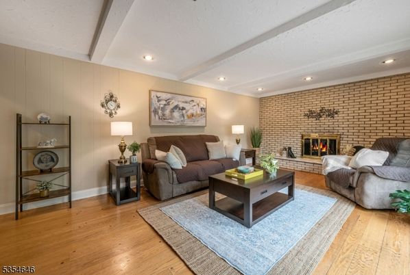 Fireplace, Interior, Living room, Recessed Lighting, Stone Walls, Wood Texture Flooring