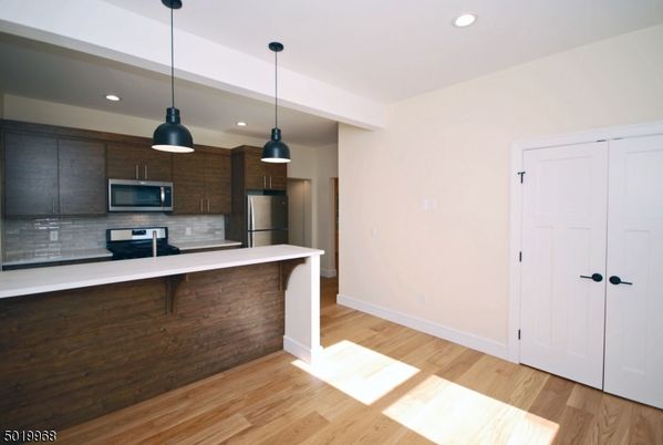 Interior, Kitchen, Pendant Lights, Recessed Lighting, Stainless Steel Appliances, Wood Texture Flooring