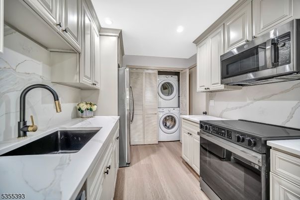 Interior, Kitchen, Marble Walls, Recessed Lighting, Stainless Steel Appliances, Utility Closets, Washer, Wood Texture Flooring