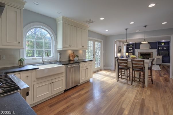 Dining room, Fireplace, Interior, Kitchen, Pendant Lights, Recessed Lighting, Stainless Steel Appliances, Wood Texture Flooring