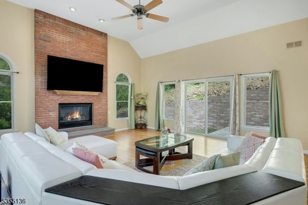 Fireplace, Interior, Living room, Recessed Lighting, Stone Walls, Wood Texture Flooring
