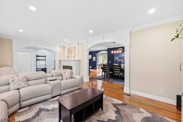 Chandelier, Dining room, Fireplace, Interior, Living room, Pendant Lights, Recessed Lighting, Wood Texture Flooring