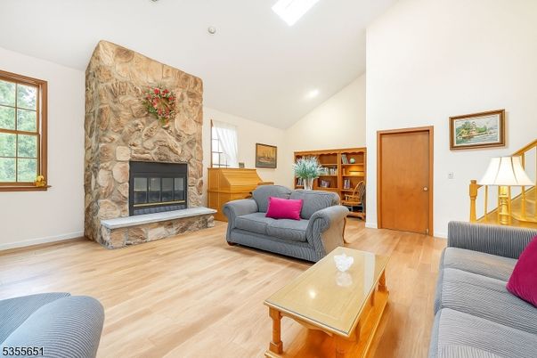 Fireplace, Interior, Living room, Recessed Lighting, Stone Walls, Wood Texture Flooring