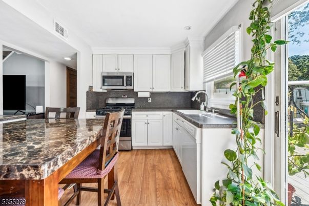 Dining room, Interior, Kitchen, Recessed Lighting, Stainless Steel Appliances, Wood Texture Flooring